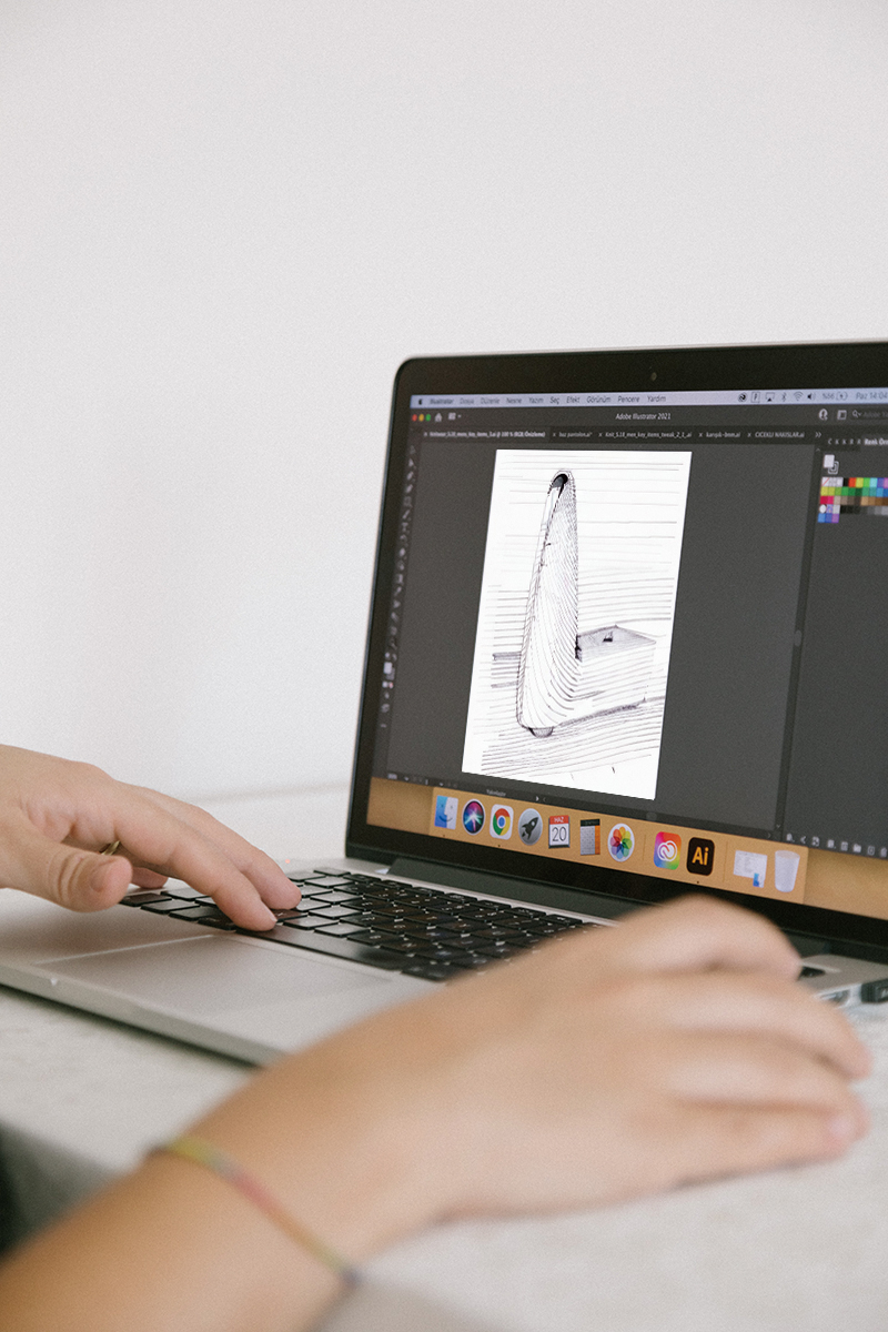 Designing sofa legs using a laptop, highlighting DELTA CAINA's innovative approach to furniture hardware customization and advanced design capabilities.
